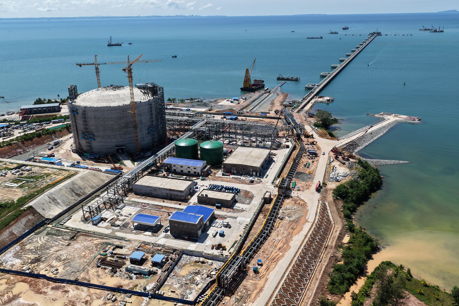 LNG terminal under construction, including the LNG storage tank and jetty